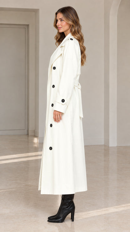 Side profile view of white longline double-breasted trench coat