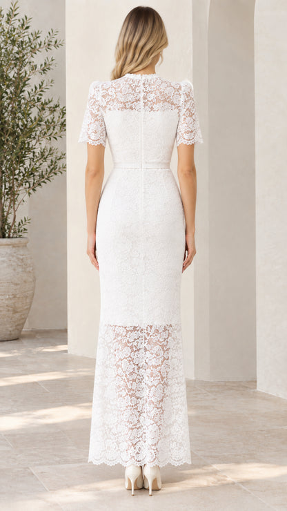 Back view of woman wearing white short sleeve lace maxi dress