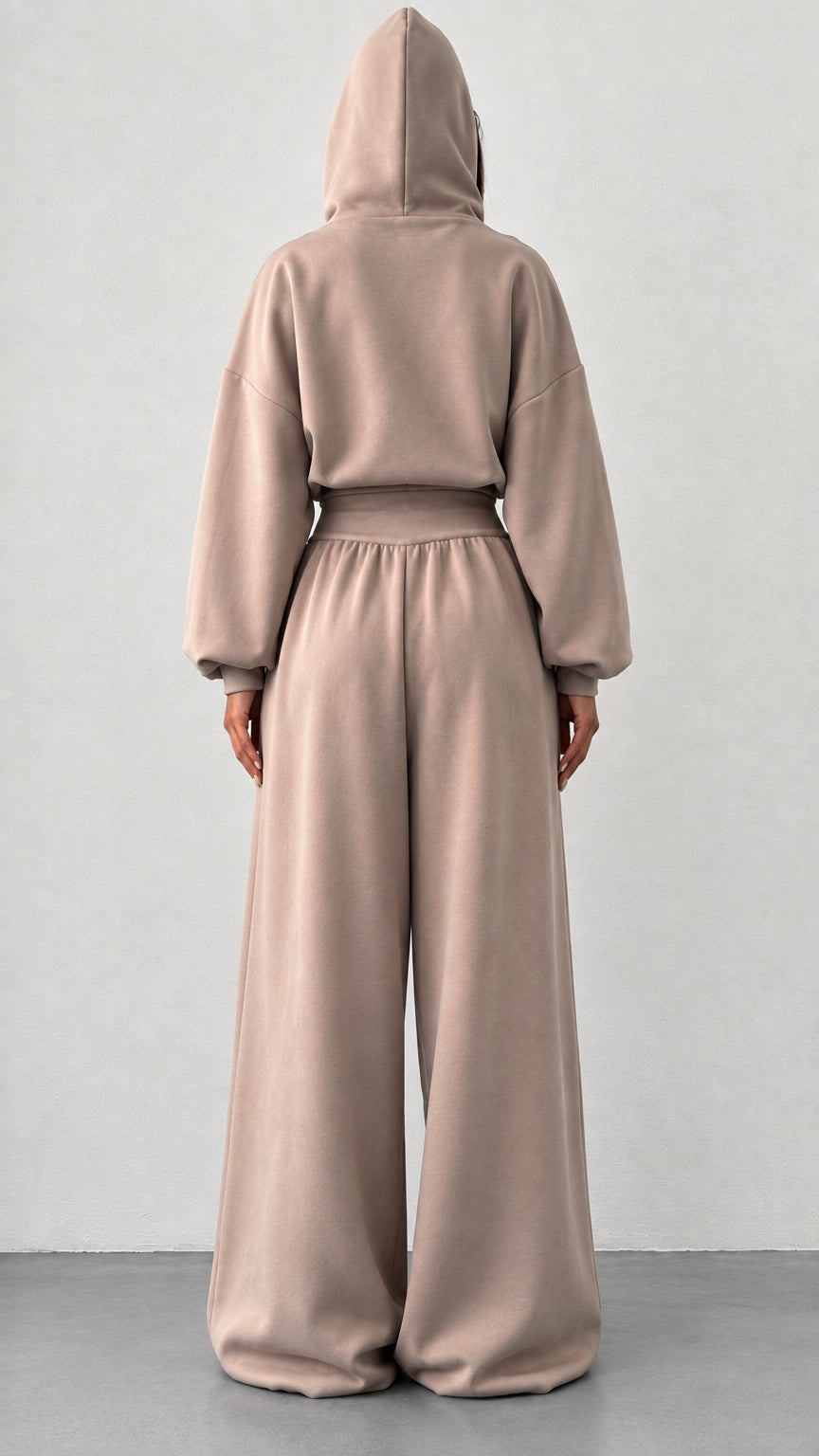 Back view of woman wearing taupe hooded two piece loungewear set
