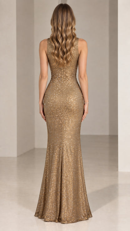 Back view of model wearing gold fitted sequin mermaid gown