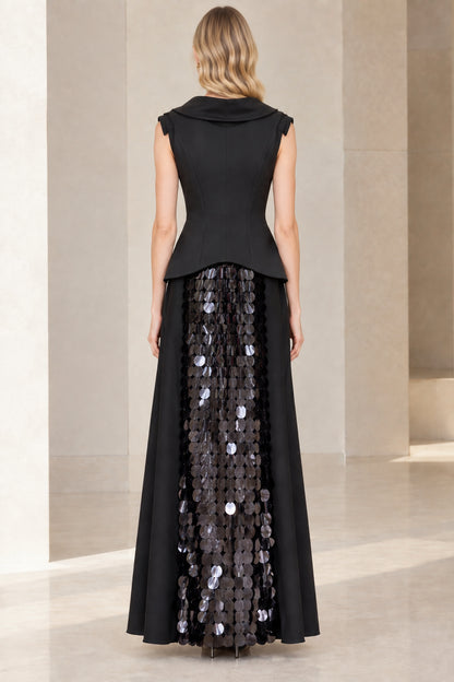 Back view of model in elegant black cowl neck maxi dress with smooth tailored peplum