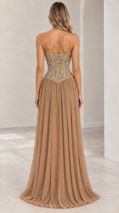Back view of champagne strapless evening gown showing fitted beaded bodice and pleated skirt