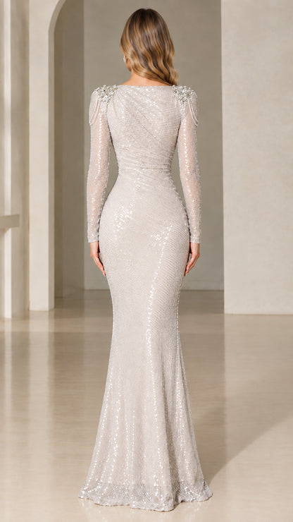 Back view of silver sequin mermaid evening gown showing fitted silhouette