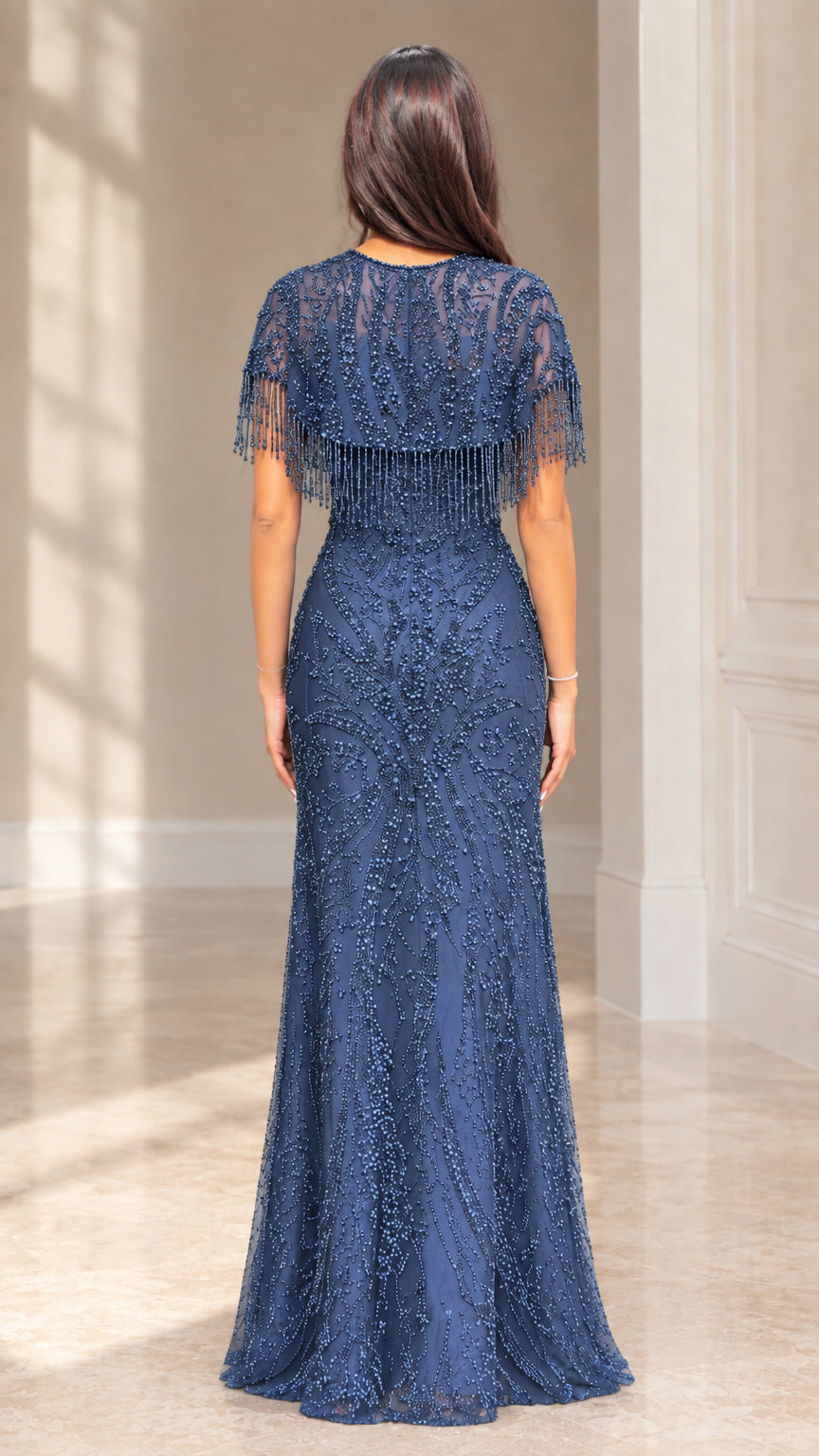 Back view of slate blue beaded formal gown showing back capelet coverage