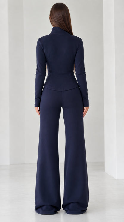 Back view of women's navy blue long sleeve top and wide-leg trousers