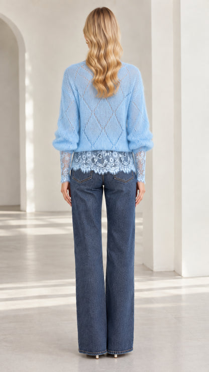 Back view of model wearing light blue diamond knit sweater with lace hem