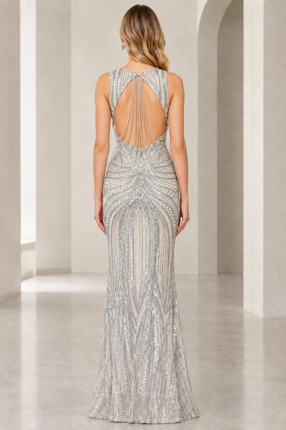 Back view of silver sequined gown showing teardrop cutout and draped bead strands