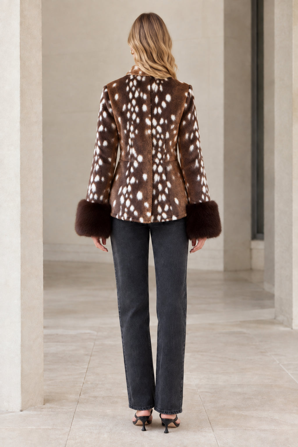 Back view of model wearing brown spotted faux fur jacket