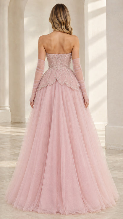 Back view of Blush Pink strapless gown with fitted bodice and flowing tulle skirt