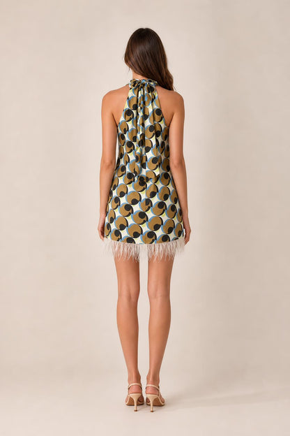 Back view of model wearing geometric halter mini dress