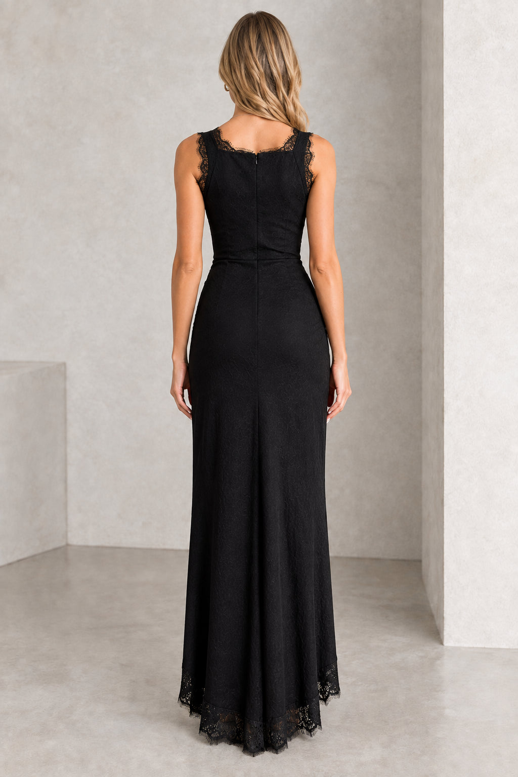 Back view of black sleeveless fitted maxi dress with lace trim