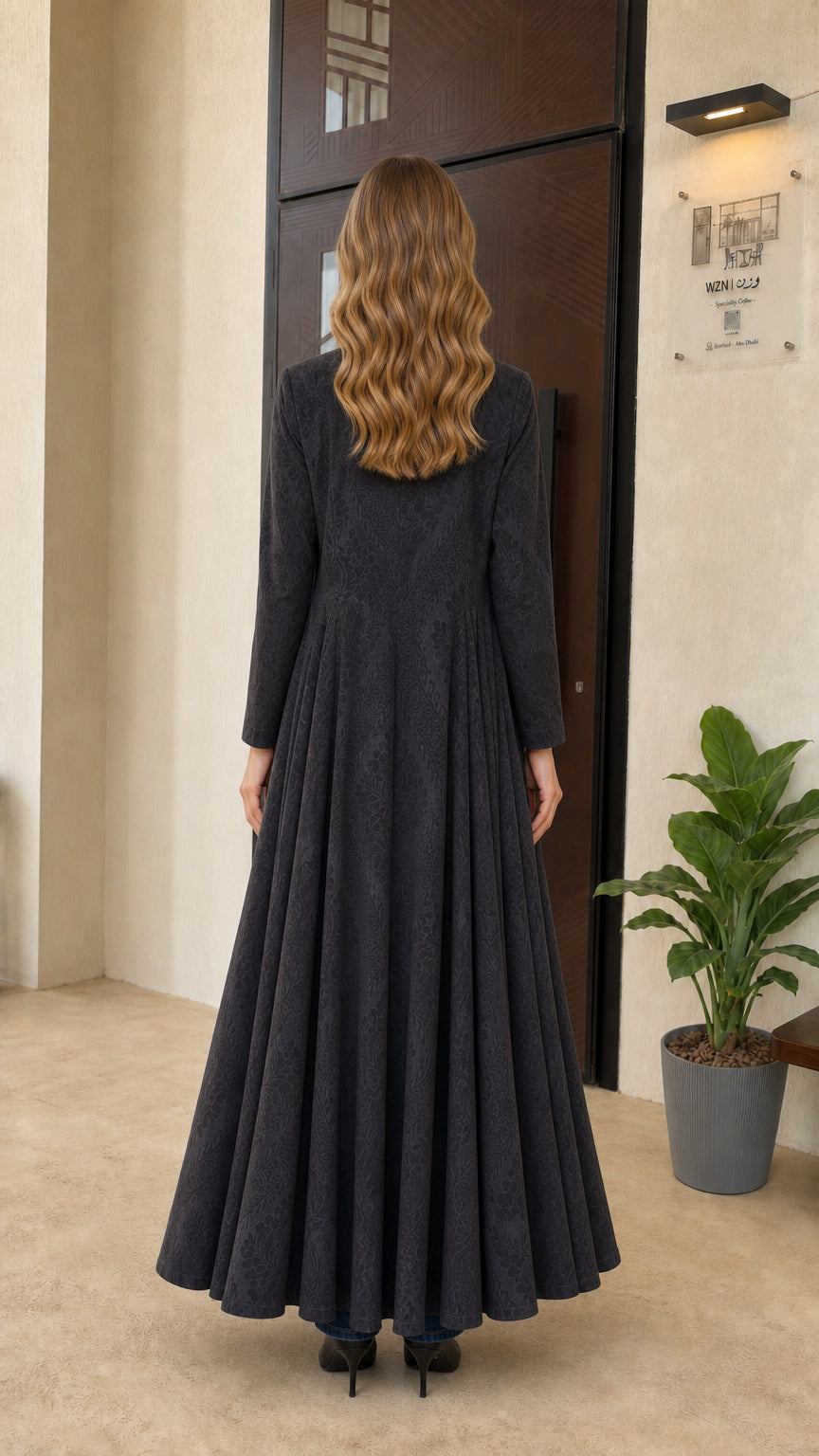 Back full-length view of charcoal grey maxi duster coat displaying pleated voluminous swing skirt