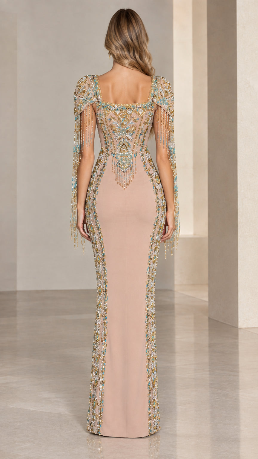 Back view of model in Nude embellished evening gown showcasing back beadwork and fringe details