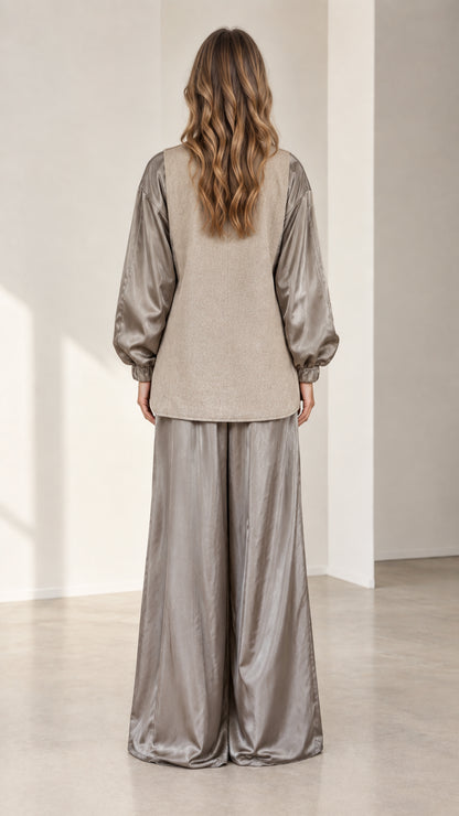 Back view of model wearing relaxed taupe contrast blazer and wide-leg trousers