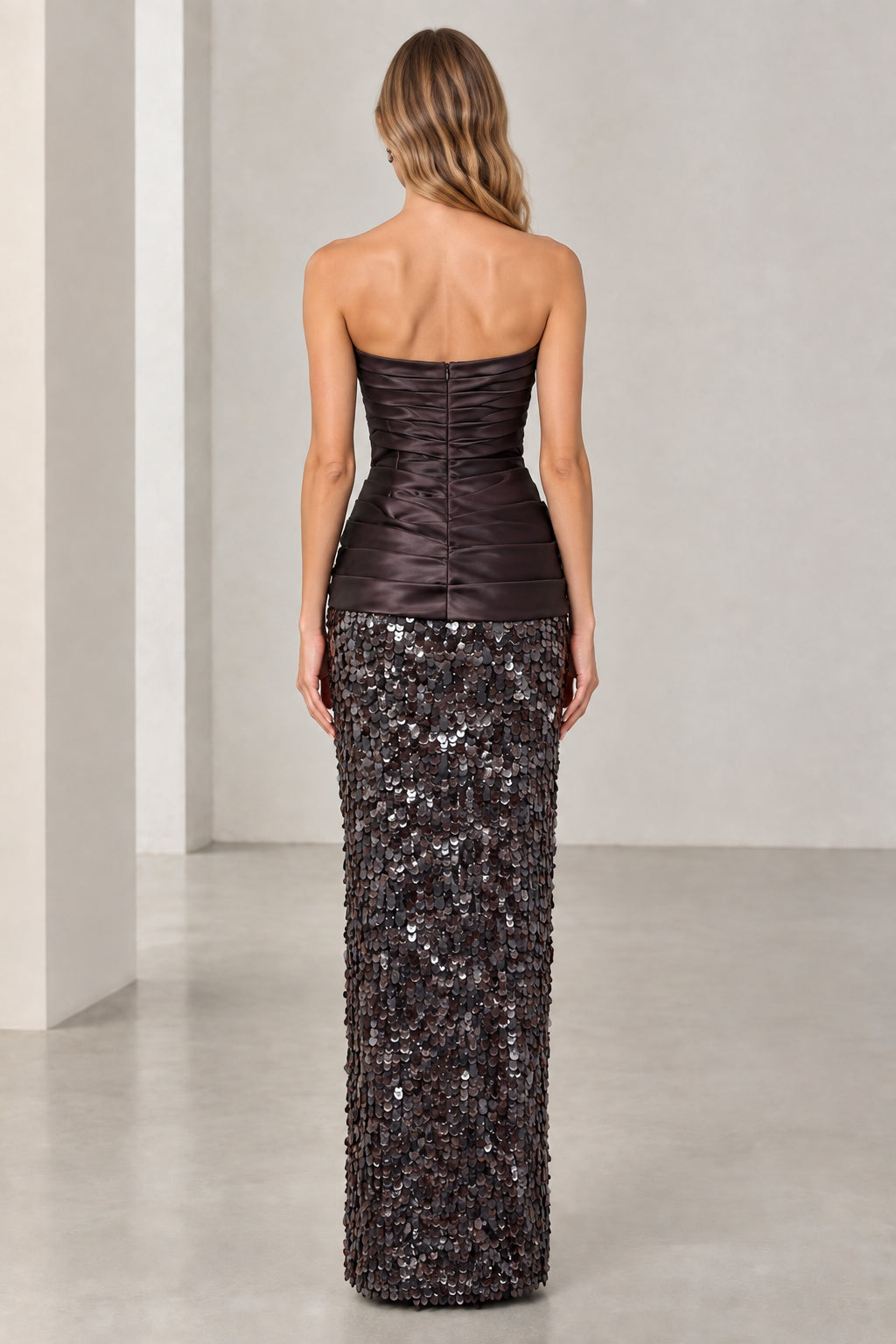 Back view of woman wearing espresso brown ruched corset and sequin maxi dress