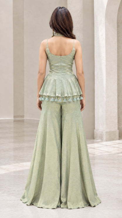 Back full view of woman wearing sage green peplum sharara set