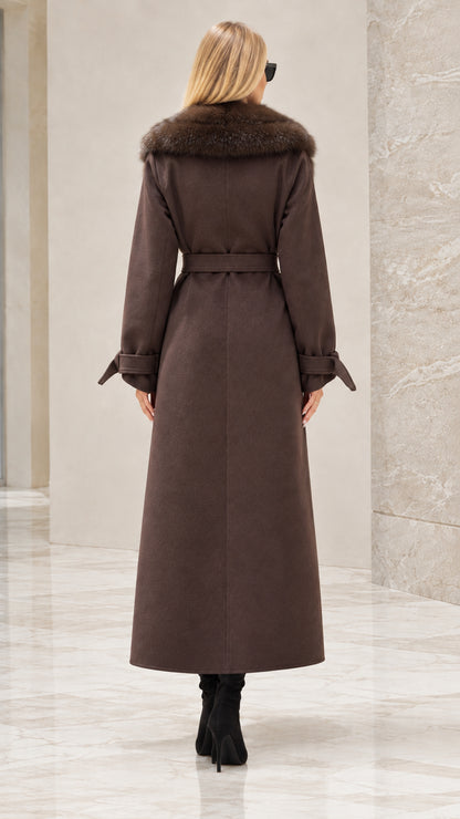 Back view of woman wearing brown maxi trench coat with waist tie