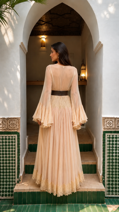 Back view of champagne maxi dress with pleated skirt, sheer sleeves, and contrast waist belt