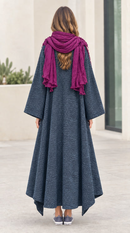 Back full-length view of woman showing the sweeping silhouette of the Slate Blue maxi coat