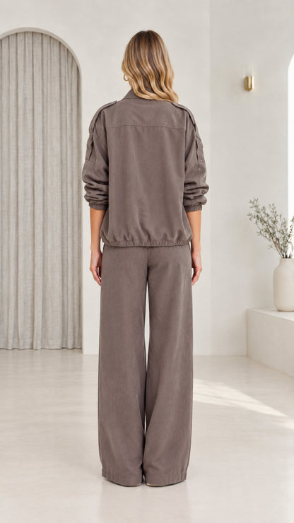 Back view of model in taupe utility jacket and matching wide-leg trousers