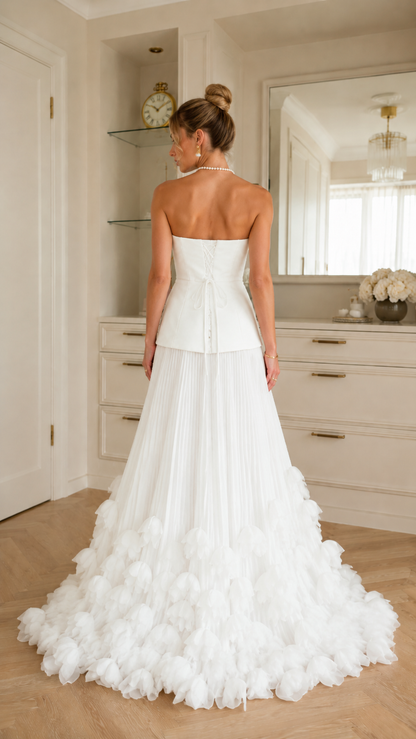 Back view of ivory strapless floor-length gown with fitted bodice and full ruffle hem