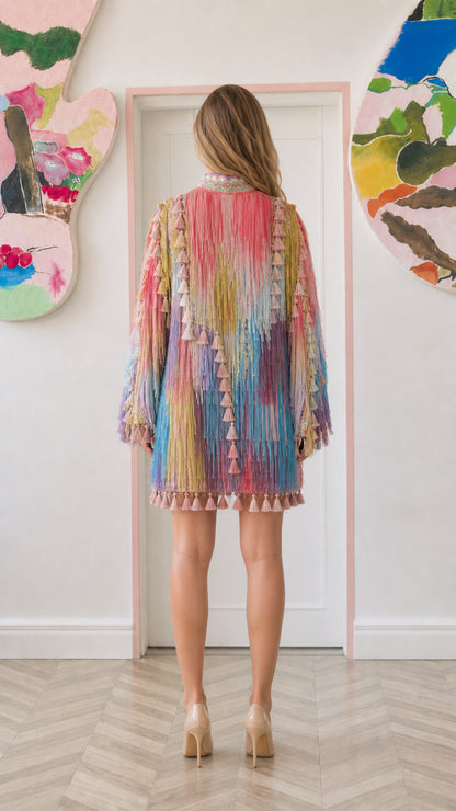 Model wearing pastel multicolor fringe tassel dress back view