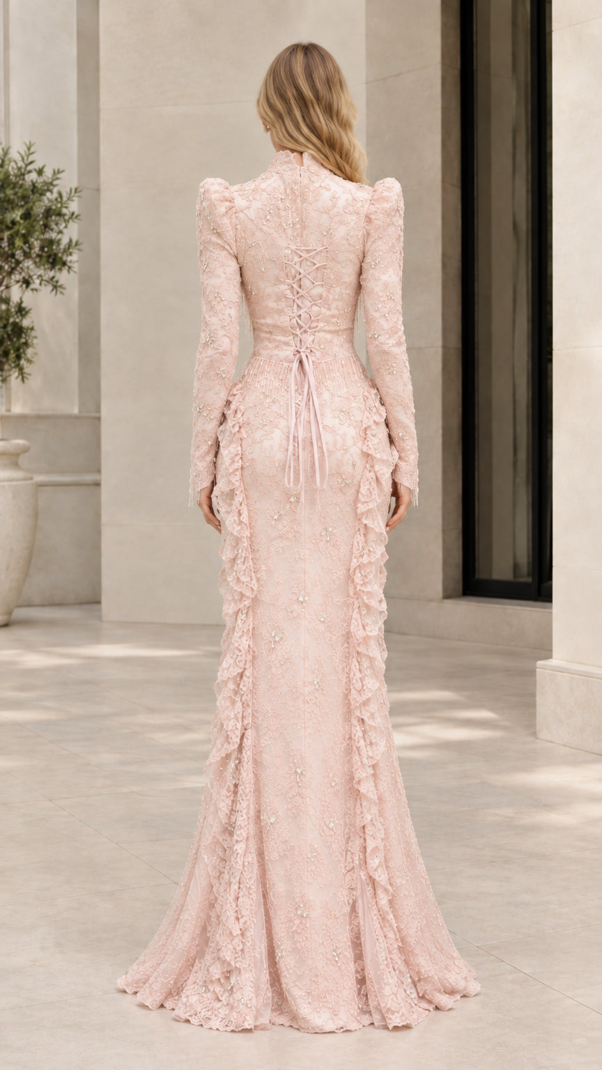 Back view of blush pink formal gown showcasing lace-up corset back detail