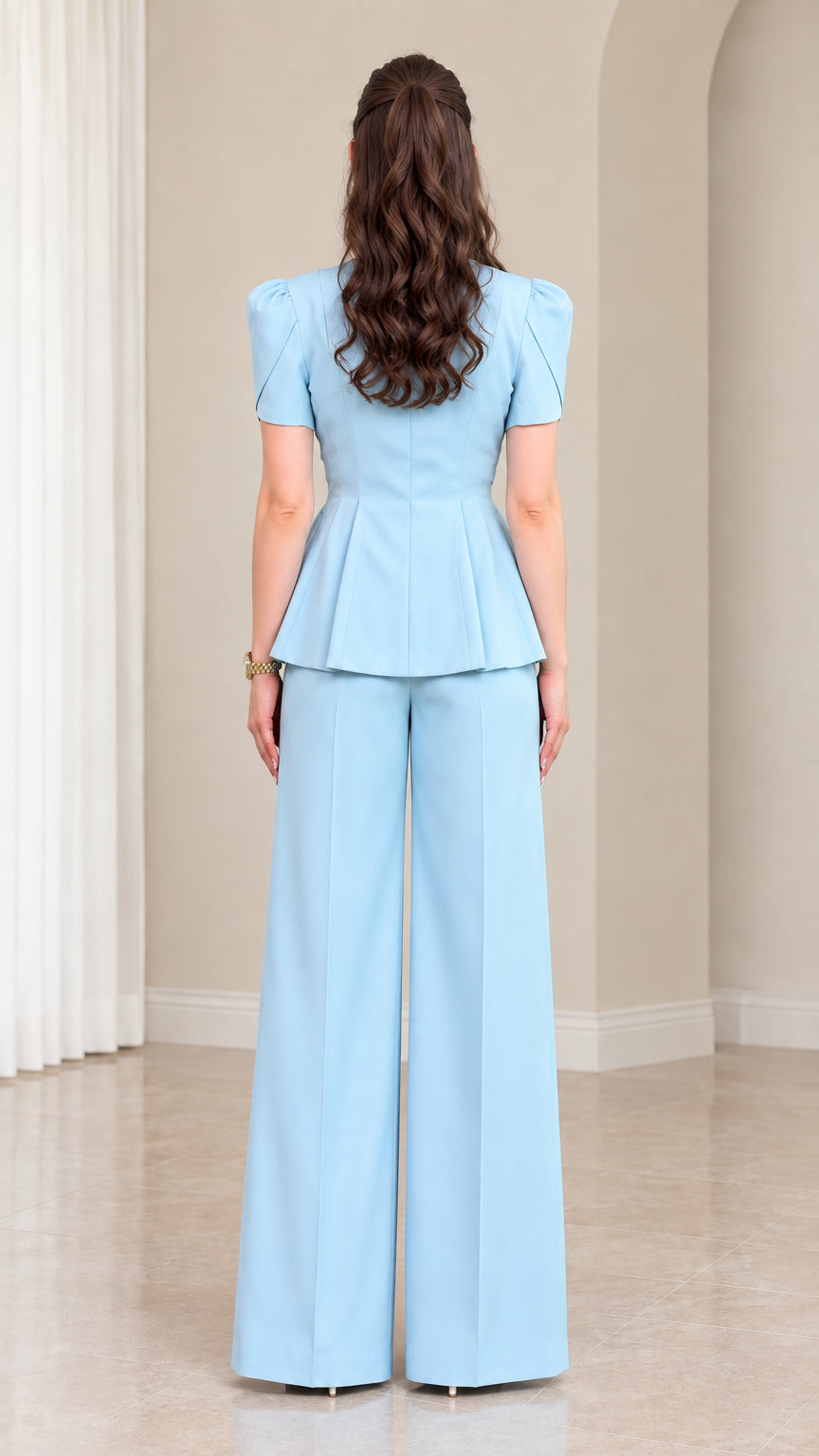 Back view of model in Sky Blue peplum two-piece pant suit