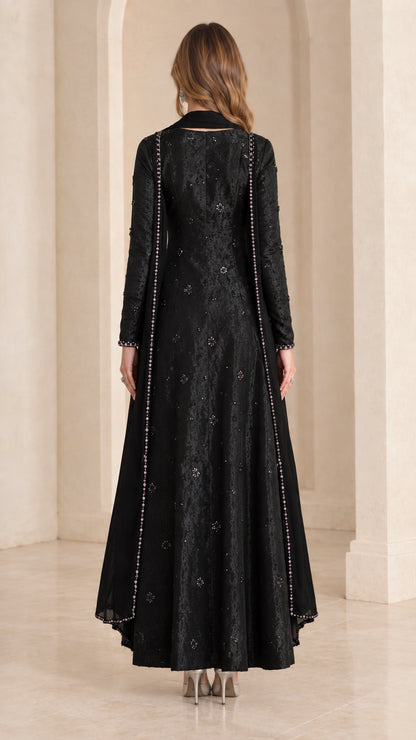 Back view of black long sleeve A-line maxi dress with matching scarf drape