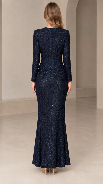Back view of model in Navy Blue sequin long sleeve formal evening set