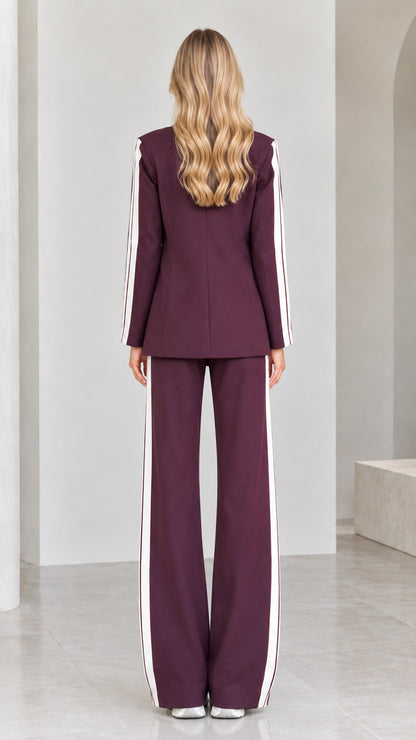 Back view of model in tailored burgundy blazer and wide-leg trousers
