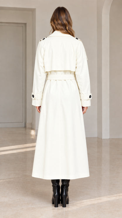 Back view of white maxi trench coat highlighting storm flap and waist belt