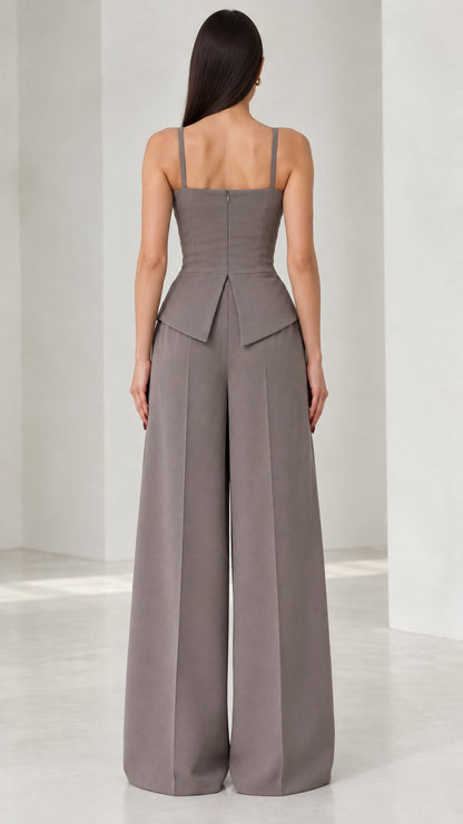 Back view of model wearing grey tailored wide leg jumpsuit with concealed zipper
