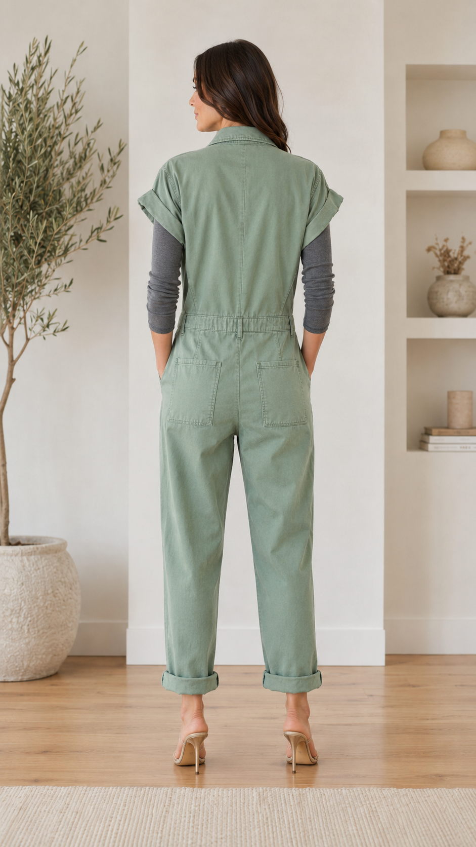 Back view of sage utility jumpsuit showing elastic waist and straight cuffed legs