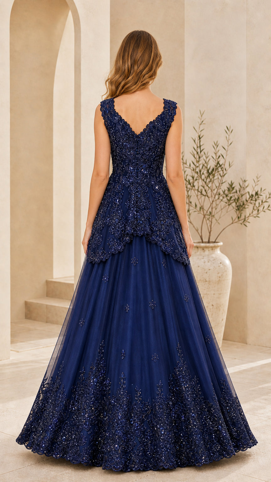 Back view of model showing V-back design in Navy Blue peplum tulle gown