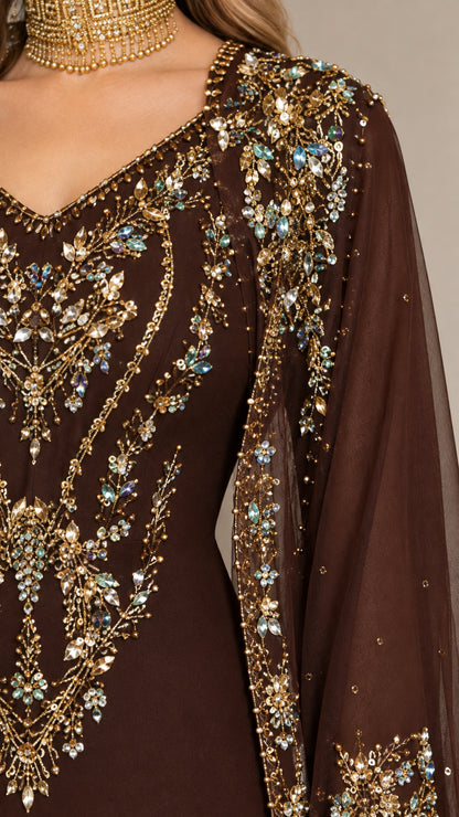 Close-up detail of shimmering gold and crystal embroidery on brown cape neckline