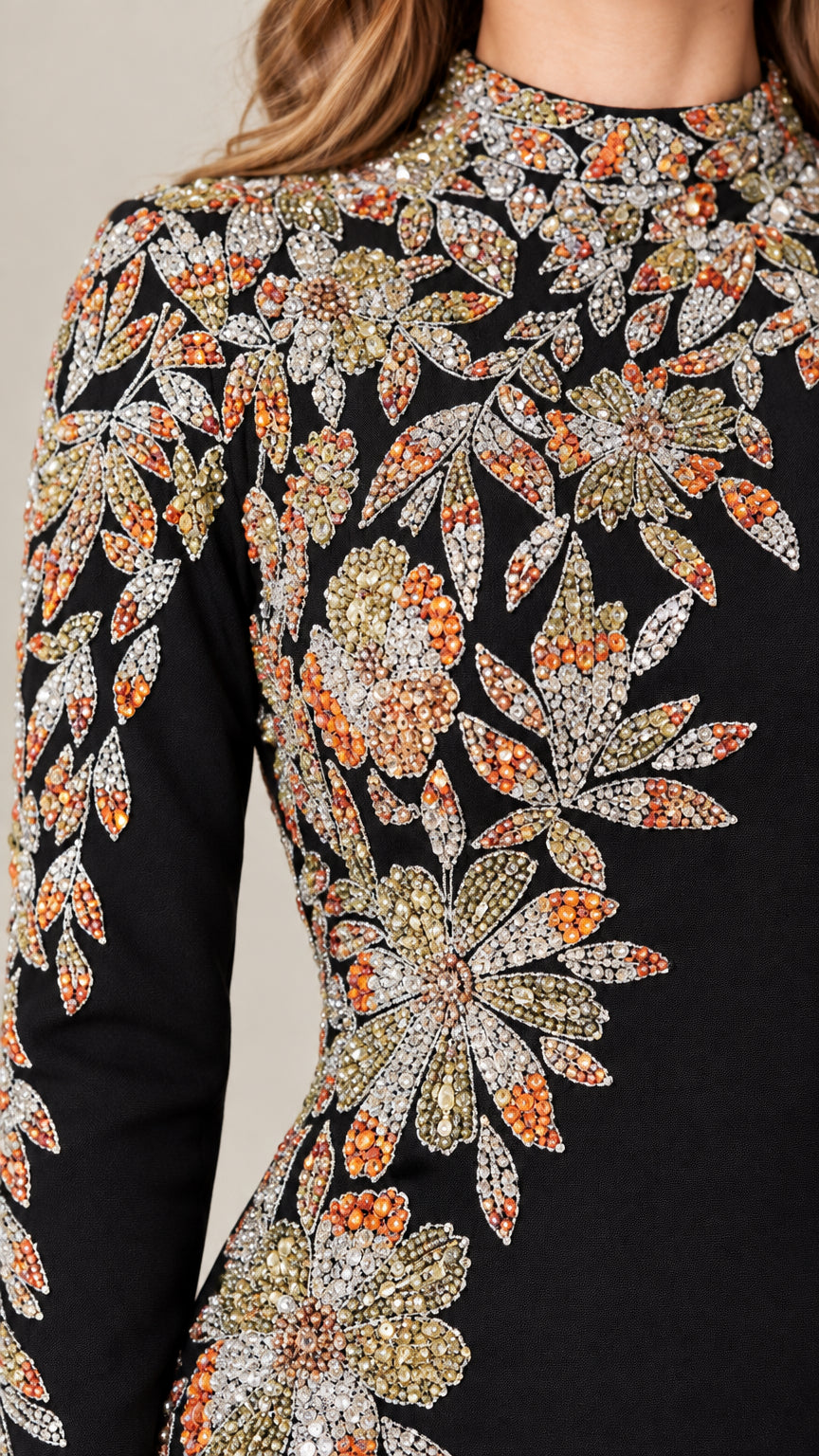 Close-up detail of multi-color floral beadwork and embroidery on evening gown