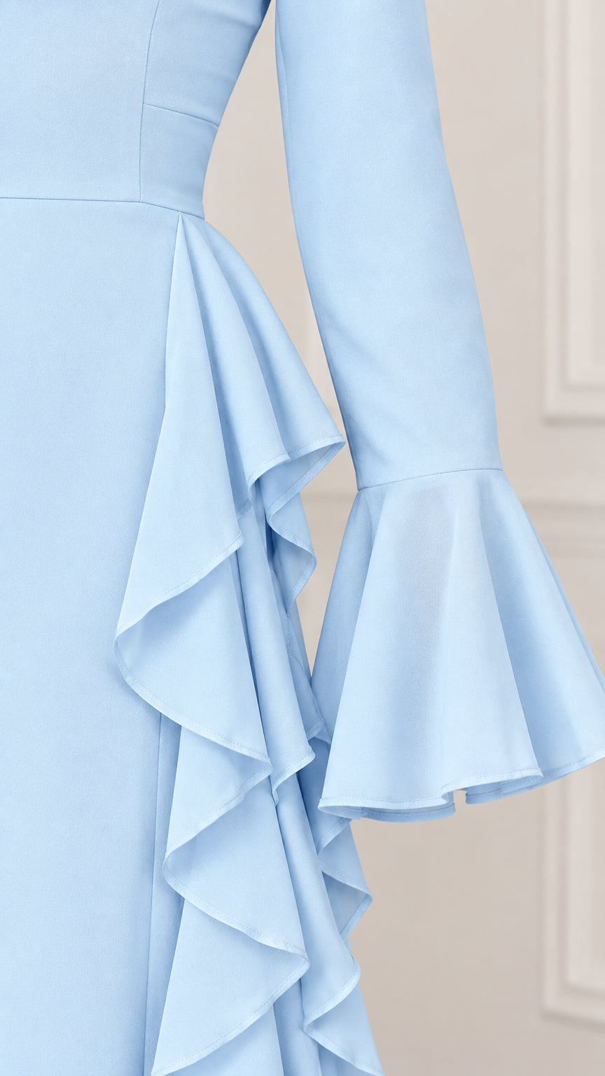 Close-up detail of flared bell sleeve and side ruffle construction in Light Blue