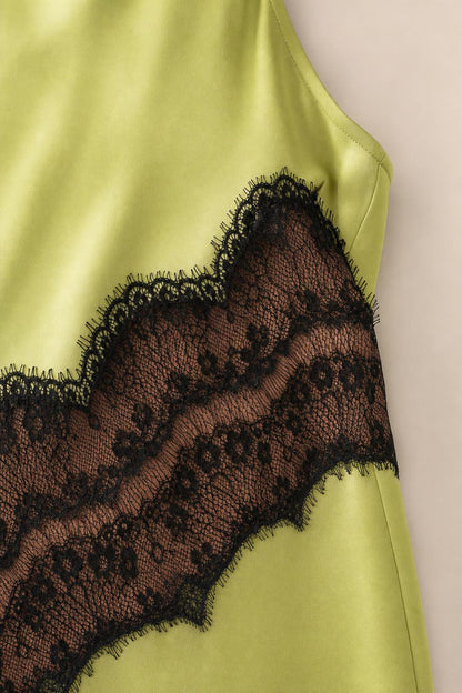 Close-up detail of sheer black lace insert on dress