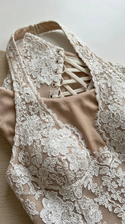 Close-up of intricate floral lace bodice and corset tie back