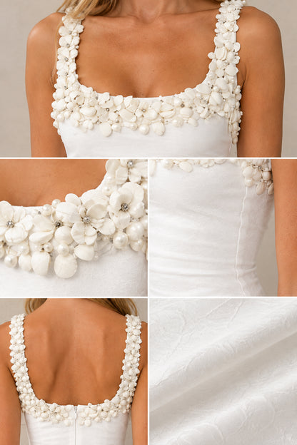 Close-up details of 3D floral trim and fabric texture on white maxi dress