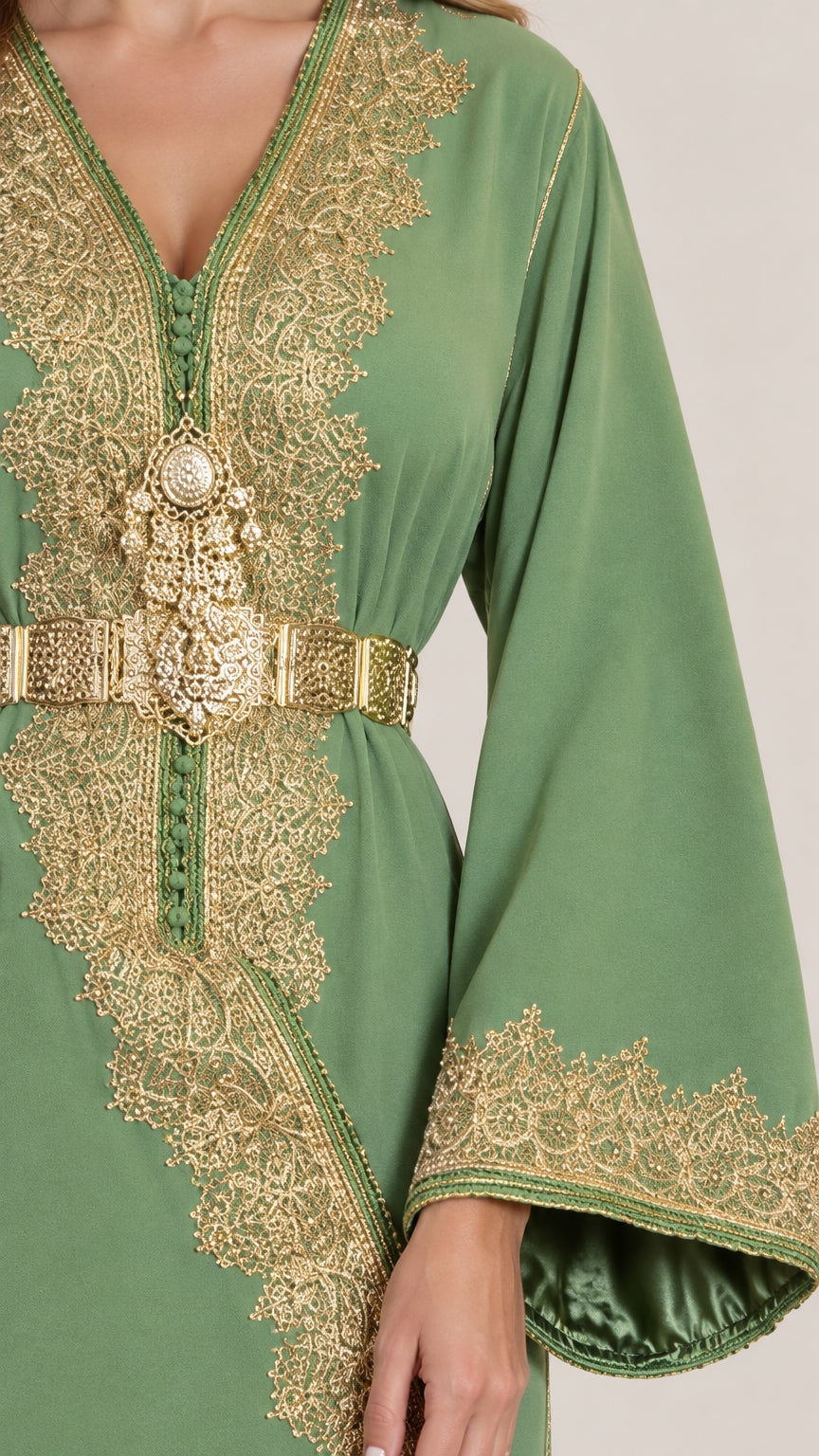 Close-up of intricate gold lace embroidery and ornate belt on sage green kaftan dress