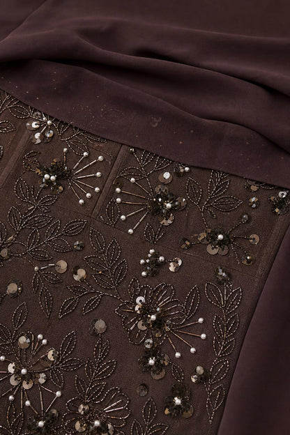 Close-up detail of sequin and bead embroidery on dress