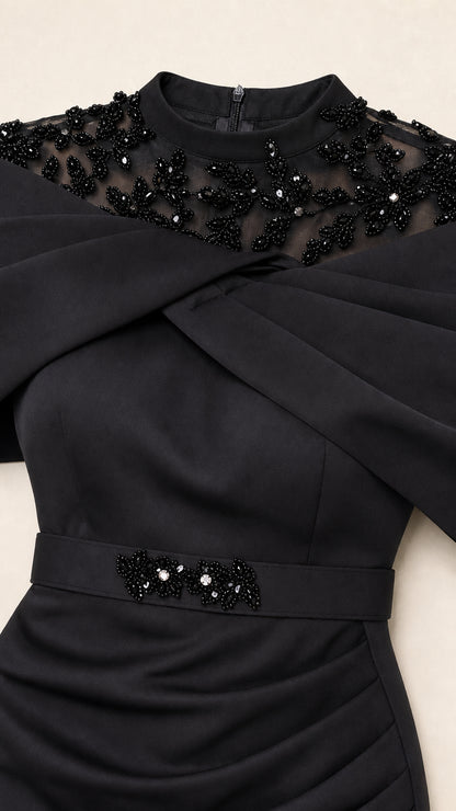 Close-up of Black dress neckline with tonal beadwork, embroidery, and ruched draped waist detail