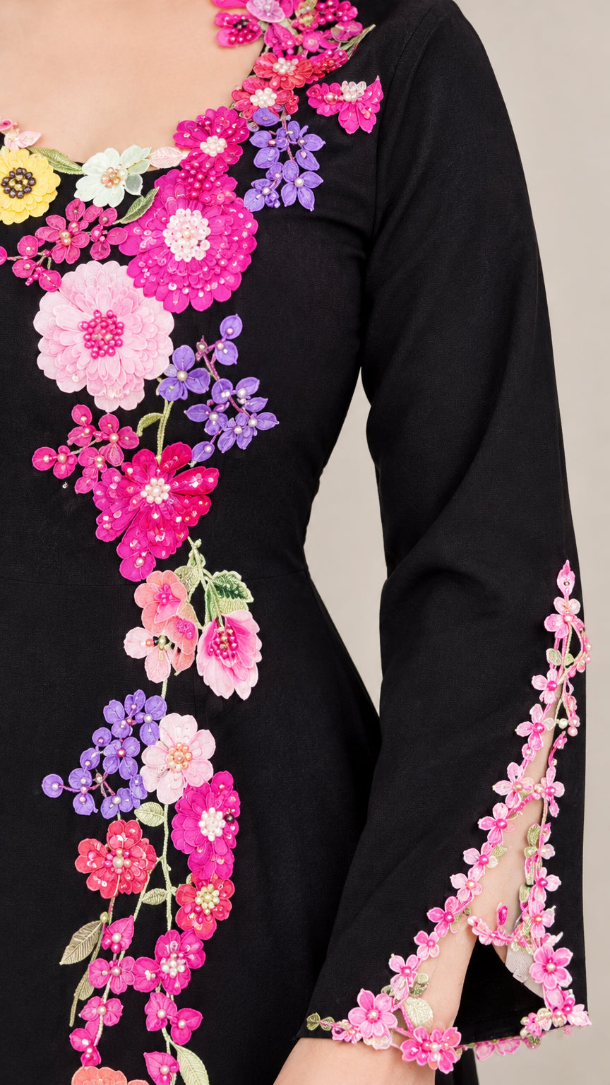 Close up of colorful 3D floral applique on neckline and sleeve cuff