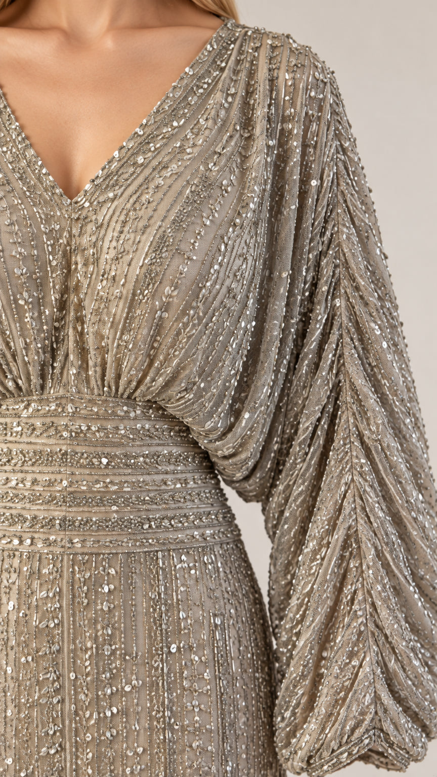 Close-up detail of intricate sequin beadwork and voluminous gathered sleeve on Champagne gown