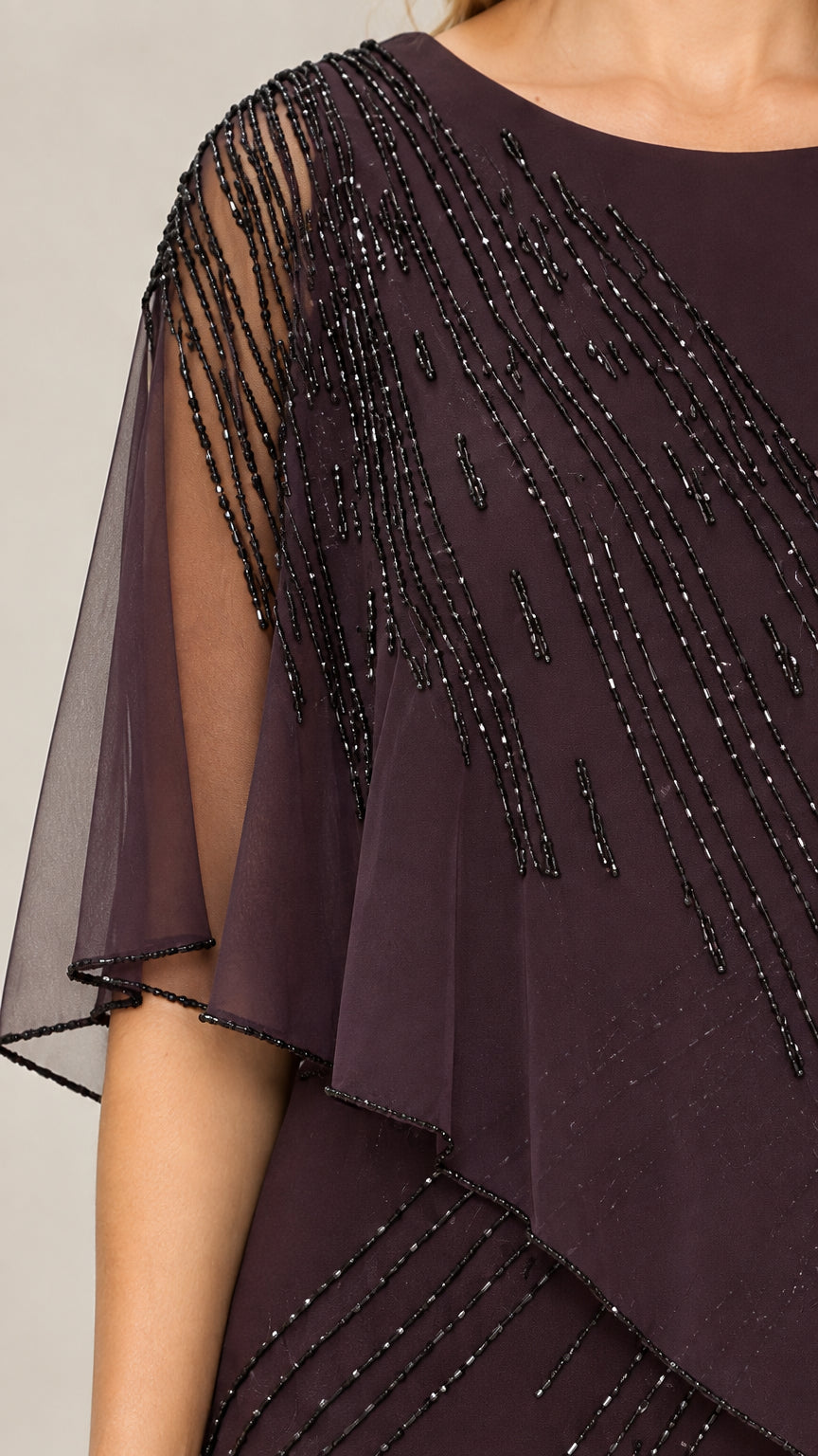 Close-up detail of sheer asymmetric cape sleeve with linear beadwork