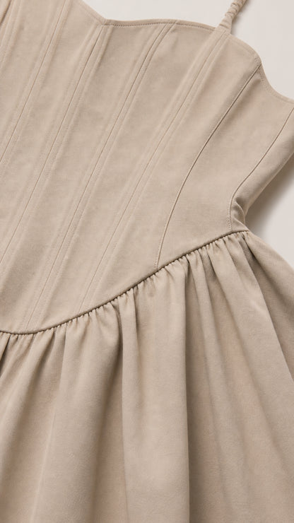 Close-up detail of structured corset paneling and gathered basque waist seam