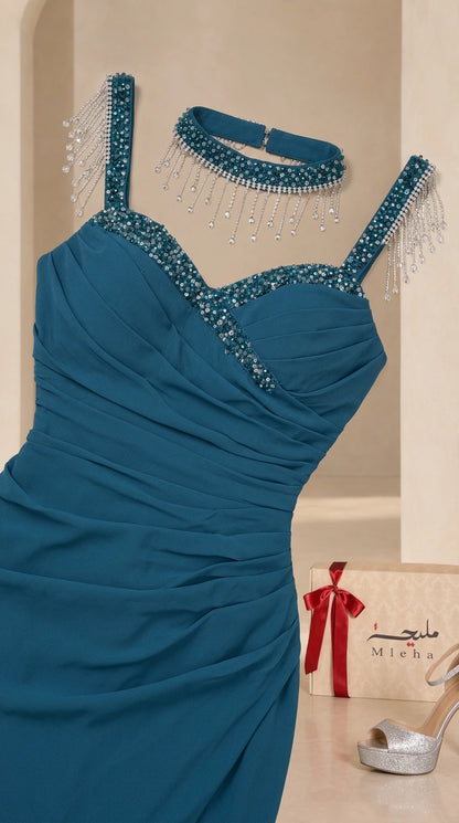 Close-up detail of beaded neckline, fringe straps, and matching choker in teal