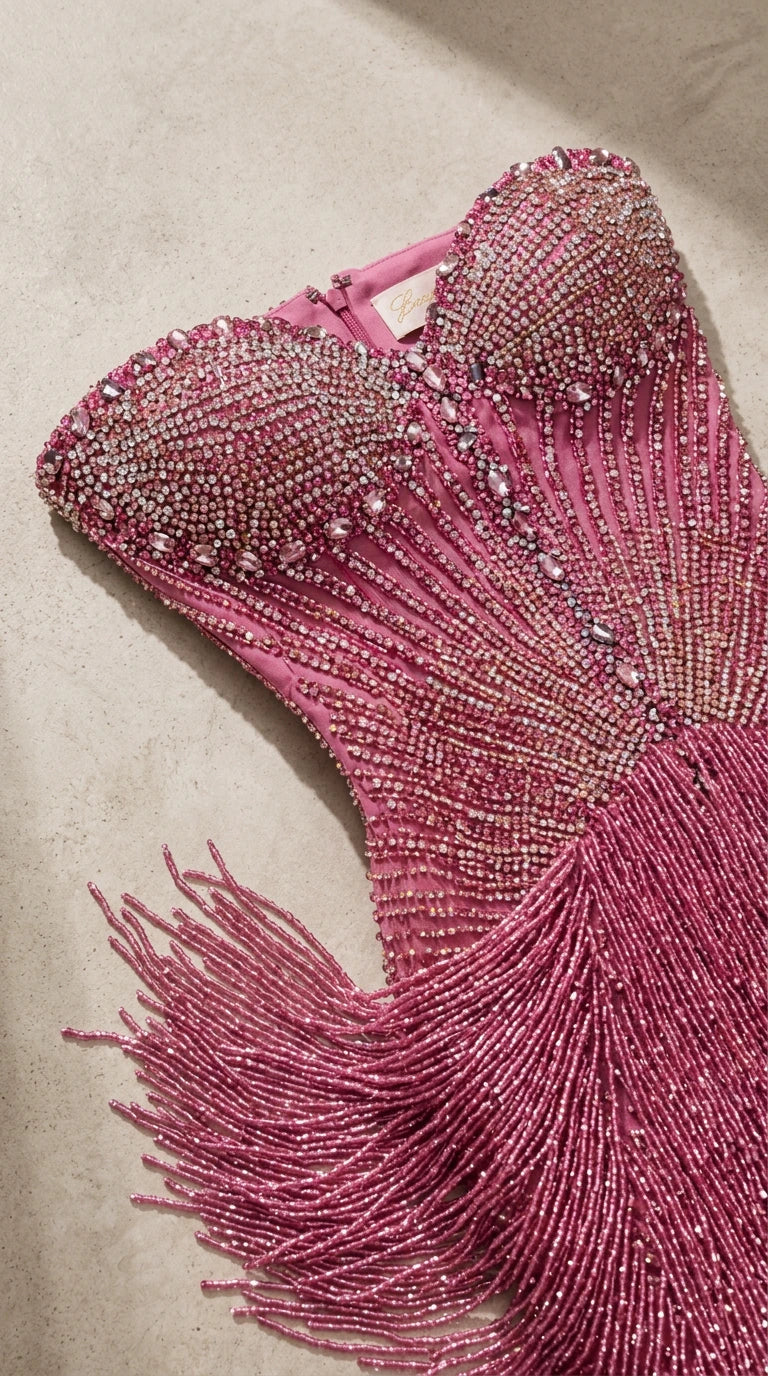 Close-up detail of rose pink sweetheart beaded corset bodice and fringe tassels